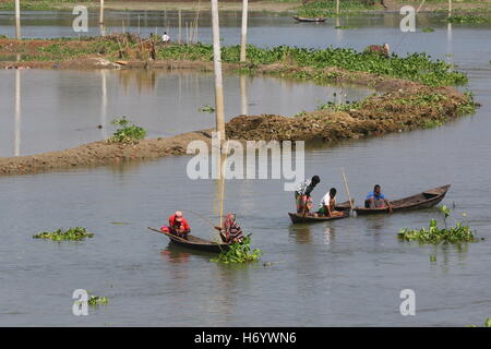 Seasonal fishermen busy fishing in the Turag river at Savar outside the capital Dhaka, with the river's water level going down. Stock Photo