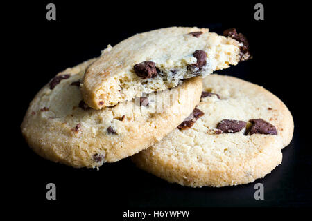 Round chocolate chip shortbread biscuits. On black. Stock Photo