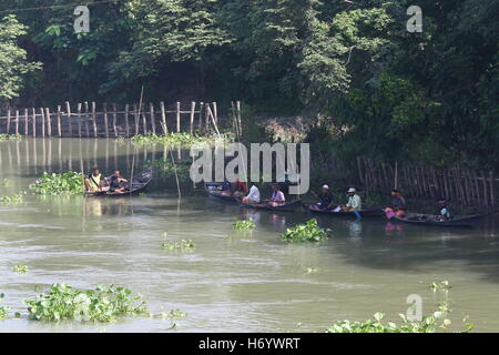 Seasonal fishermen busy fishing in the Turag river at Savar outside the capital Dhaka, with the river's water level going down. Stock Photo