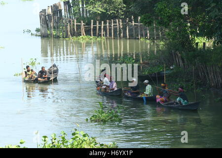 Seasonal fishermen busy fishing in the Turag river at Savar outside the capital Dhaka, with the river's water level going down. Stock Photo