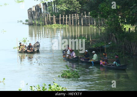 Seasonal fishermen busy fishing in the Turag river at Savar outside the capital Dhaka, with the river's water level going down. Stock Photo