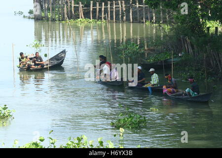 Seasonal fishermen busy fishing in the Turag river at Savar outside the capital Dhaka, with the river's water level going down. Stock Photo