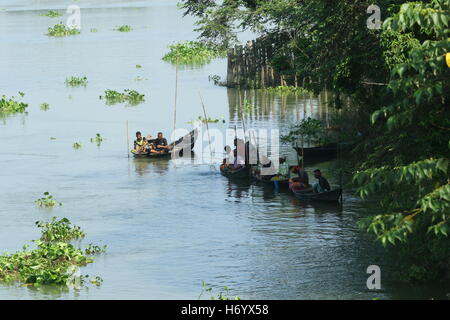 Seasonal fishermen busy fishing in the Turag river at Savar outside the capital Dhaka, with the river's water level going down. Stock Photo