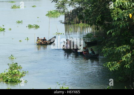 Seasonal fishermen busy fishing in the Turag river at Savar outside the capital Dhaka, with the river's water level going down. Stock Photo