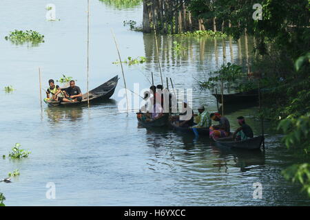 Seasonal fishermen busy fishing in the Turag river at Savar outside the capital Dhaka, with the river's water level going down. Stock Photo