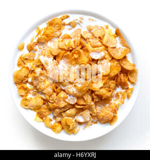 Bowl of cornflakes in milk isolated on white from above. Stock Photo