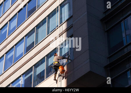 A worker washing windows on a building in Ottawa, Ontario, Canada. Stock Photo