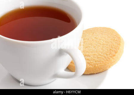 Detail of a white ceramic cup of rooibos tea with shortbread biscuits. Stock Photo