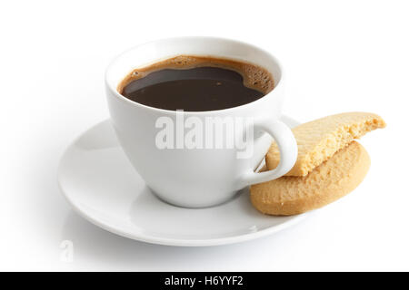 White ceramic cup and saucer with black coffee and shortbread biscuits. Isolated. Stock Photo