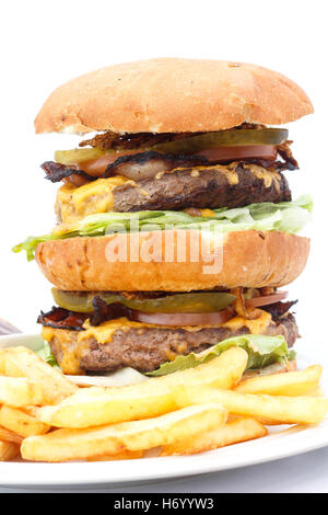 Double cheese burger and chips with ketchup on a white plate. Stock Photo