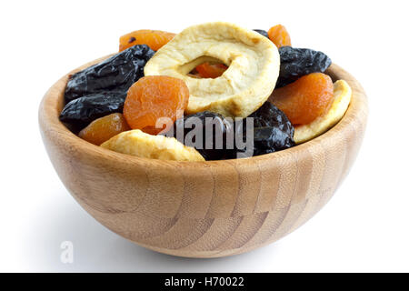 Wooden bowl of mixed dried fruit isolated on white. In perspective. Stock Photo