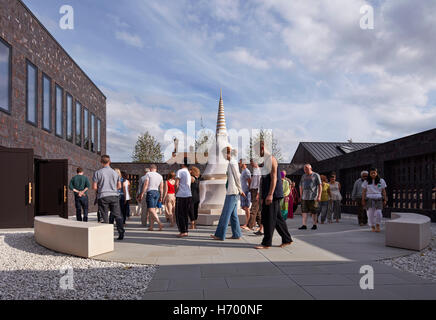 Stupa courtyard during ceremony. Vajrasana Retreat, Walsham-le-Willows, United Kingdom. Architect: Walters and Cohen Ltd, 2016. Stock Photo