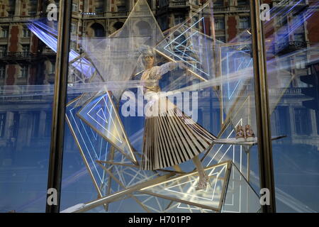 Female mannequin in store window. Reflections of the surrounding buildings. Stock Photo