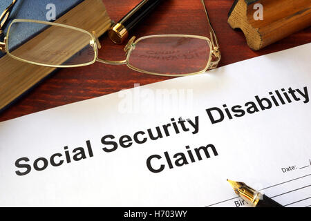 Social security disability claim on a wooden table. Stock Photo