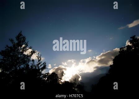 Moon shining through the clouds Stock Photo