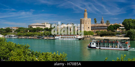 Spain, Seville, Torre del Oro, the Golden tower and cruise boat on the river Guadalquivir Stock Photo