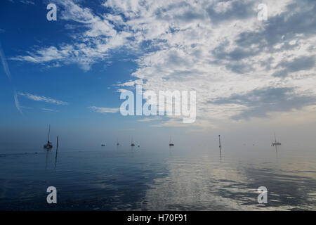 Various Yachts at Rest on Flat Calm Sea off Chalkwell Stock Photo