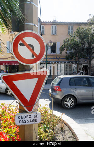 No left turn sign with give way sign in French Stock Photo