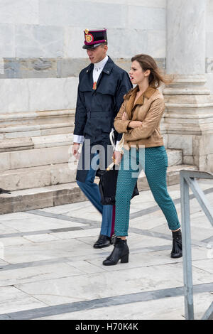 The young man in military uniform with young woman walking near Pisa Cathedral , city in Tuscany, Central Italy Stock Photo