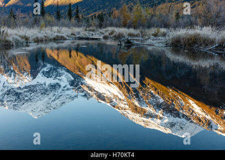 Reflection of Eagle Peak and Chugach Mountains in beaver pond in Chugach State Park in Southcentral Alaska. Autumn. Morning. Stock Photo