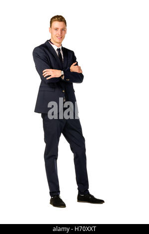 Full length portrait of young businessman with arms crossed standing ...