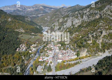 AERIAL VIEW. Medieval village surrounded by autumnal colors in the upper Var Valley. Guillaumes, Alpes-Maritimes, France. Stock Photo
