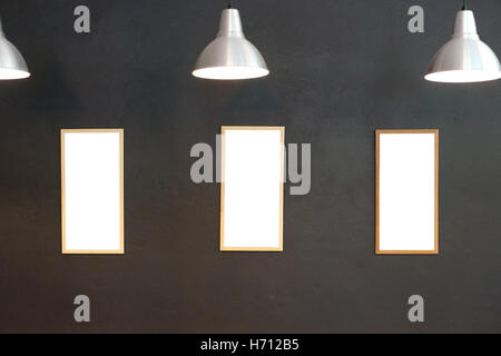 gallery interior, empty picture frames on the wall with lighting Stock Photo
