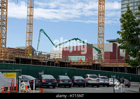 This is a construction horizontal image with a large cement pumper being used. Stock Photo