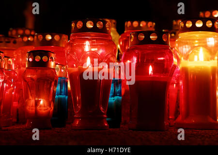 burning candles on cemetery during All Saints Day Stock Photo