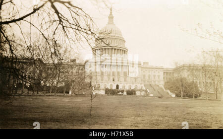 Antique c1920 photograph, the US Capitol Building in Washington, DC. The United States Capitol, often called the Capitol Building or Capitol Hill, is the seat of the United States Congress. It sits atop Capitol Hill, at the eastern end of the National Mall in Washington, D.C. SOURCE: ORIGINAL PHOTOGRAPHIC PRINT. Stock Photo