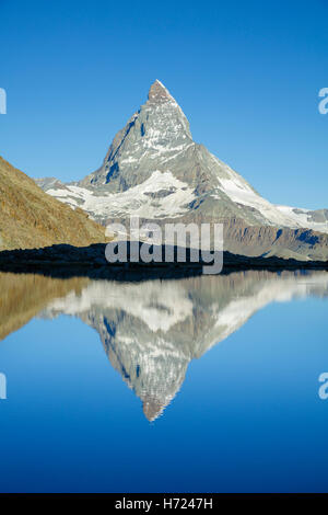 The Matterhorn reflected in the Riffelsee, Zermatt, Pennine Alps, Valais, Switzerland. Stock Photo