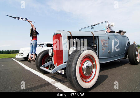 Starter girl starting a hot rod race, with a Ford Model B in front, Hot Rods, Kustoms, Cruisers & Art at the 'Bottrop Kustom Stock Photo