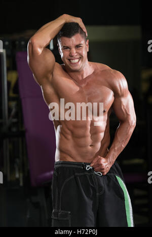 Man Standing Showing ABS. Muscle man Posing. Strong Body Concept