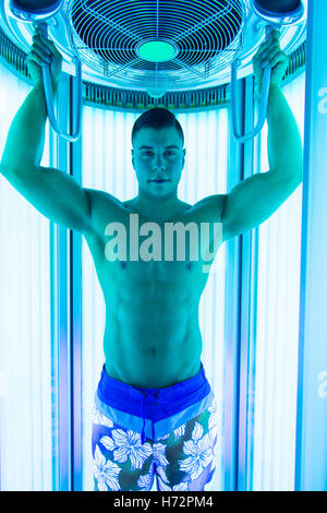 Young man in tanning bed retro image from the early 90's Stock Photo