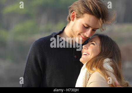 Happy couple hugging in love outdoors Stock Photo