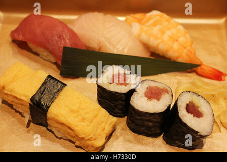 Sushi set including Sushi rolls, Sashimi and Nigiri served in a restaurant at Osaka, Japan Stock Photo
