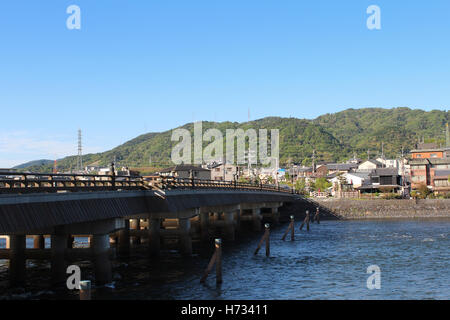 View of Uji city with the Uji Bridge, Uji River, houses, mountain and blue sky, Japan Stock Photo