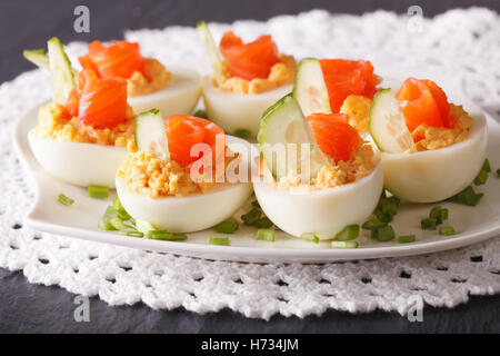 Eggs stuffed with salmon close-up on a plate on the table. horizontal Stock Photo
