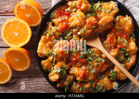Delicious orange chicken fillets close-up on a plate on the table. horizontal view from above