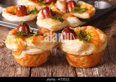 Freshly baked muffins with sausage, cheese and onion close-up on the table. horizontal Stock Photo