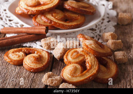 Tasty cookies Palmiers with sugar and cinnamon on the table close-up, horizontal Stock Photo