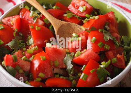 Vitamin tomato salad with herbs in a bowl close-up. horizontal Stock Photo