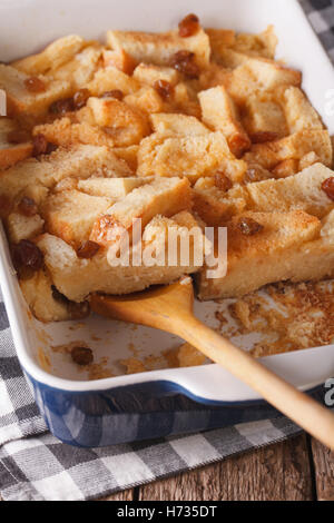 An English cake in a baking dish on a wooden board and a white wooden  table. Selective focus Stock Photo - Alamy