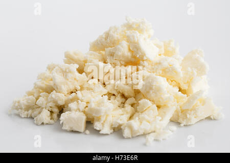 Crumbled white feta cheese isolated on white surface. Stock Photo