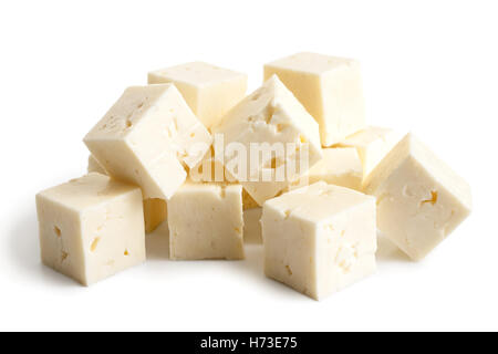 Square cubes of feta cheese isolated on white in perspective. Stock Photo