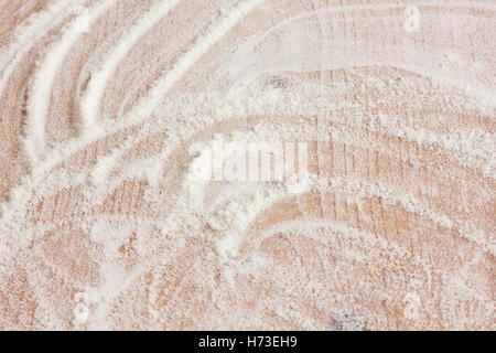 White flour on a rustic old kitchen board. Stock Photo