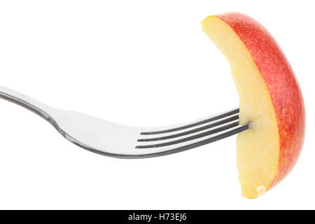 Single slice of red apple on a fork. Stock Photo