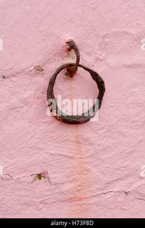 Rusted metal mooring ring on sea wall Stock Photo