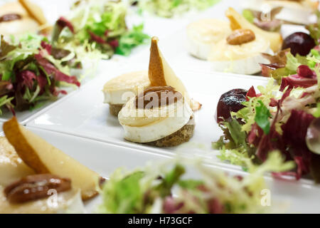 Melted round of goats cheese on bread with salad. Stock Photo