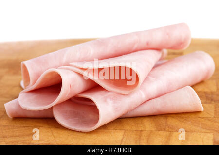 Processed ham randomly arranged on chopping board. Stock Photo